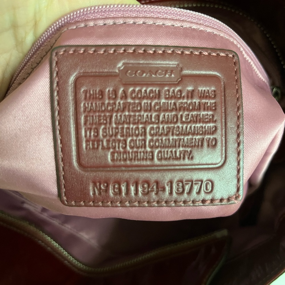 Coach patent leather deep red in color. Mid size purse